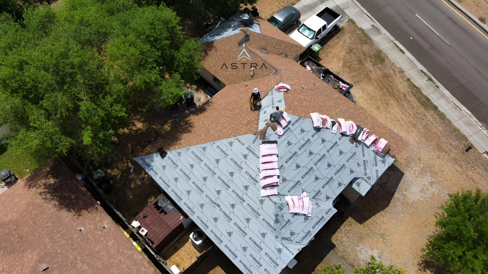 Astra Roofing crew installing a roof from above